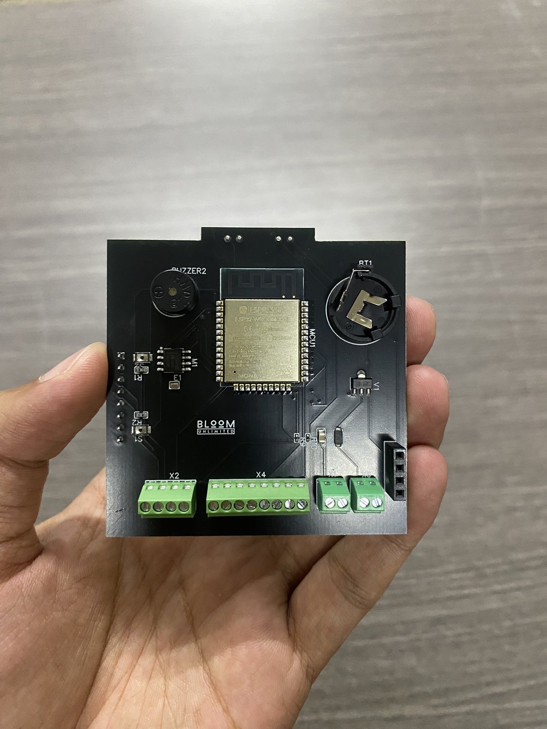 Assembled compact ESP32 controller PCB with screw terminals, buttons and buzzer